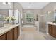 Bright bathroom featuring a large soaking tub, glass enclosed shower and and sinks at 111 Falling Water Dr, Brandon, FL 33511