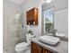 Bright bathroom featuring a walk-in shower and modern sink with wood toned vanity at 111 Falling Water Dr, Brandon, FL 33511