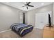 Simple bedroom with a ceiling fan, plush carpet, a bed with striped bedding, and a large closet at 111 Falling Water Dr, Brandon, FL 33511
