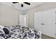 Neutral bedroom featuring a ceiling fan, plush carpet, and a closet with white double doors at 111 Falling Water Dr, Brandon, FL 33511