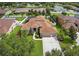 Aerial view of a well-maintained home featuring a lush front yard, mature landscaping, and a long concrete driveway at 111 Falling Water Dr, Brandon, FL 33511