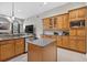 Open kitchen with granite countertops and custom cabinets, showing island and bar seating at 111 Falling Water Dr, Brandon, FL 33511