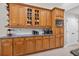 Kitchen features classic wood cabinetry and granite countertops, showcasing functional design at 111 Falling Water Dr, Brandon, FL 33511