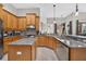 Kitchen featuring stainless steel appliances, custom wood cabinets, granite counters, and an island cooktop at 111 Falling Water Dr, Brandon, FL 33511