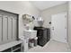 Well-lit laundry room featuring a sink, modern washer and dryer, and plenty of storage space at 111 Falling Water Dr, Brandon, FL 33511