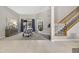 Open-concept living room featuring carpet floors, a staircase with wooden banister, and lots of natural light at 111 Falling Water Dr, Brandon, FL 33511