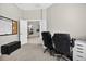 Well-lit office space offering ample room for two desks, a calendar, and a view to other rooms at 111 Falling Water Dr, Brandon, FL 33511