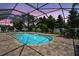 This screened in pool area features a kidney bean style pool and plenty of seating at 111 Falling Water Dr, Brandon, FL 33511