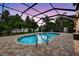Screened in backyard pool features privacy landscaping and ample brick paver patio for seating at 111 Falling Water Dr, Brandon, FL 33511