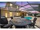 Covered and screened poolside dining area perfect for entertaining friends and Gathering while grilling out at 111 Falling Water Dr, Brandon, FL 33511
