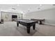 Expansive recreation room with a pool table, air hockey table, and mounted TV for entertainment at 111 Falling Water Dr, Brandon, FL 33511