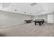 A large, carpeted recreation room features a pool table and air hockey, perfect for entertainment at 111 Falling Water Dr, Brandon, FL 33511