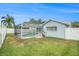 Fenced backyard featuring a screened-in pool enclosure and well-kept lawn at 11222 Clayridge Dr, Tampa, FL 33635