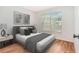 Staged bedroom features a large window with blinds and wood-look flooring at 11222 Clayridge Dr, Tampa, FL 33635