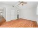 Bright bedroom featuring wood floors, a ceiling fan, and ensuite bathroom access at 11222 Clayridge Dr, Tampa, FL 33635
