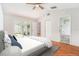 Staged bedroom with wood floors, ceiling fan, and sliding door access to lanai at 11222 Clayridge Dr, Tampa, FL 33635