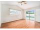 Bedroom with hardwood flooring, a ceiling fan and sliding glass doors leading to the pool area at 11222 Clayridge Dr, Tampa, FL 33635