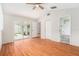 Bright bedroom featuring laminate flooring, a ceiling fan, and direct access to the screened-in pool area at 11222 Clayridge Dr, Tampa, FL 33635