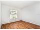 Bedroom featuring a window with blinds and wood-look flooring at 11222 Clayridge Dr, Tampa, FL 33635
