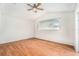 Well-lit bedroom featuring wood-look floors, a ceiling fan, and bright window at 11222 Clayridge Dr, Tampa, FL 33635