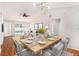Open-concept dining area with modern lighting, neutral decor, and views of the outdoor pool area at 11222 Clayridge Dr, Tampa, FL 33635