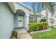 Charming home's entry featuring a decorated front door, inviting archway, and well-manicured landscaping at 11222 Clayridge Dr, Tampa, FL 33635