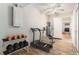 Bright workout room featuring a ceiling fan and exercise equipment leading into the kitchen at 11222 Clayridge Dr, Tampa, FL 33635