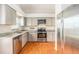 Modern kitchen featuring stainless steel appliances, gray cabinetry and granite countertops at 11222 Clayridge Dr, Tampa, FL 33635