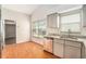 Bright kitchen nook area with hardwood flooring, granite countertop and stainless steel dishwasher at 11222 Clayridge Dr, Tampa, FL 33635