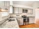 Updated kitchen with stainless steel appliances, granite countertops and light gray cabinets at 11222 Clayridge Dr, Tampa, FL 33635