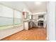 Bright kitchen featuring stainless steel appliances and gray cabinets illuminated by natural light at 11222 Clayridge Dr, Tampa, FL 33635