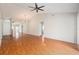 Spacious living room with hardwood floors, ceiling fan and mirrored accent wall for an open and airy feel at 11222 Clayridge Dr, Tampa, FL 33635