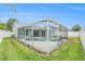 View of the refreshing pool with a screened enclosure, surrounded by a lush green yard and a well-maintained fence at 11222 Clayridge Dr, Tampa, FL 33635