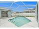 Private screened-in pool with clear blue water, surrounded by a white patio at 11222 Clayridge Dr, Tampa, FL 33635