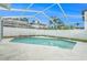 Outdoor pool inside the screened enclosure with a well-maintained concrete patio, surrounded by lush greenery and a white fence at 11222 Clayridge Dr, Tampa, FL 33635