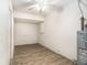 An empty storage room featuring a ceiling fan and a hot water heater at 11222 Clayridge Dr, Tampa, FL 33635