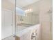 Bathroom with double vanity, granite countertop, and tiled shower with glass partition at 11429 Drifting Leaf Dr, Riverview, FL 33579