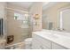 Bathroom with white vanity, tile shower, toilet, and glass shower door at 11429 Drifting Leaf Dr, Riverview, FL 33579