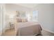 Comfortable bedroom with soft lighting, a side table, and a large window at 11429 Drifting Leaf Dr, Riverview, FL 33579