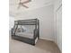 Neutral bedroom featuring a bunk bed with built-in storage, a ceiling fan, and a closet at 11429 Drifting Leaf Dr, Riverview, FL 33579
