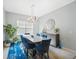 Elegant dining room with chandelier lighting, stylish decor, and bright natural light at 11429 Drifting Leaf Dr, Riverview, FL 33579