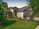 Charming home featuring a well-manicured lawn, lush landscaping, and a welcoming two-car garage at 11429 Drifting Leaf Dr, Riverview, FL 33579