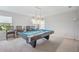 Spacious game room featuring a pool table, a decorative light, and comfortable seating at 11429 Drifting Leaf Dr, Riverview, FL 33579