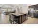 Modern kitchen featuring granite countertops, stainless steel appliances, and a spacious island with seating at 11429 Drifting Leaf Dr, Riverview, FL 33579