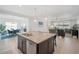Open kitchen featuring a center island with seating, connecting to the dining and living areas at 11429 Drifting Leaf Dr, Riverview, FL 33579