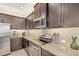 Well-equipped kitchen boasting stainless steel appliances, granite countertops, and ample cabinet space at 11429 Drifting Leaf Dr, Riverview, FL 33579