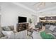 Inviting living room with stylish furnishings, an entertainment center, and an open connection to the kitchen at 11429 Drifting Leaf Dr, Riverview, FL 33579