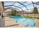 Inviting screened-in pool area with a spacious brick patio, lounge chairs, and well-maintained landscaping at 11429 Drifting Leaf Dr, Riverview, FL 33579