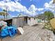 Rear exterior view showcasing wooden deck and fencing at 131 92Nd Ave, Treasure Island, FL 33706
