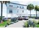 Charming waterfront home on stilts featuring an expansive driveway and a coastal landscape at 131 92Nd Ave, Treasure Island, FL 33706
